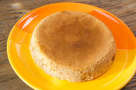 sweet apple cake on orange plate on a wooden table