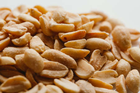 bunch of kernel peanuts on a light background closeup.の写真素材