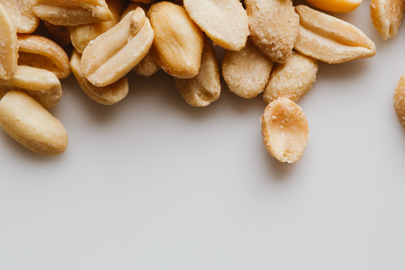 bunch of kernel peanuts on a light background closeup.の写真素材
