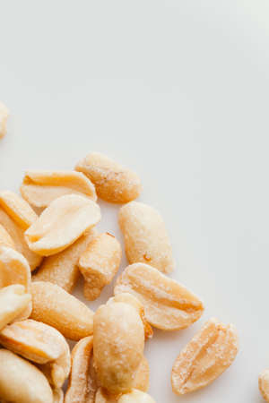 bunch of kernel peanuts on a light background closeup.の写真素材