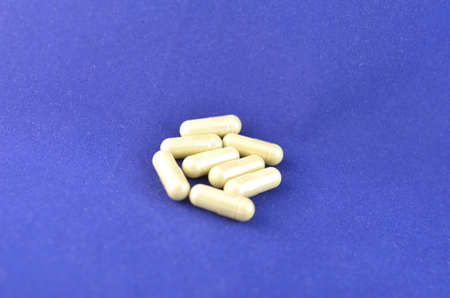 Capsules with a medicine on a blue backgroundの写真素材
