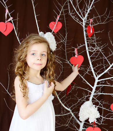Beautiful girl near a white tree of Love