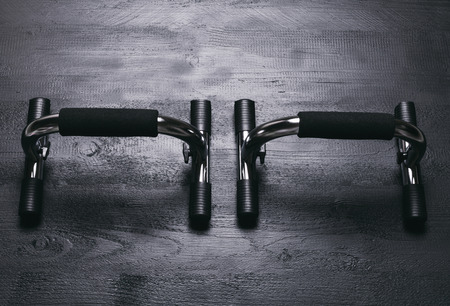 Push-up bars on black wooden backgroundの写真素材