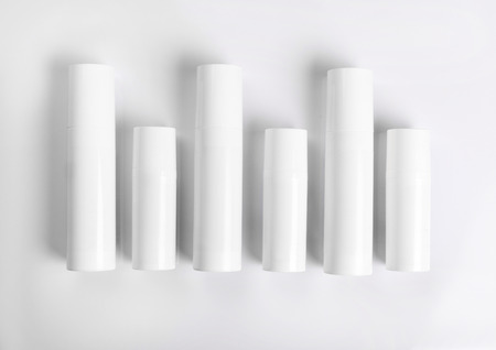 Blank cosmetic tubes on white background. White and silver colors. Place for your textの写真素材