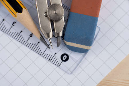 Compass, pencil, eraiser and ruler on the copybookの写真素材