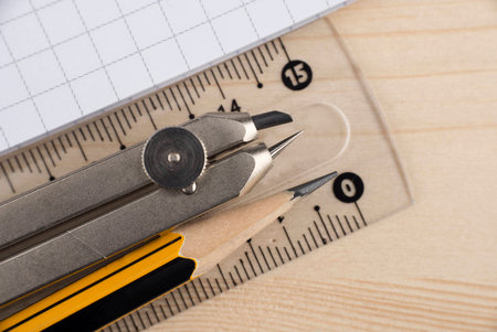 Compass, pencil and ruler on the copybook
