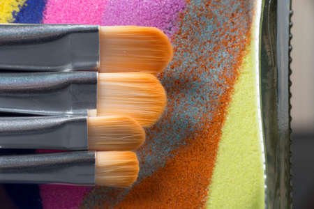 Four cosmetic brushes on the colorful background in macroの写真素材