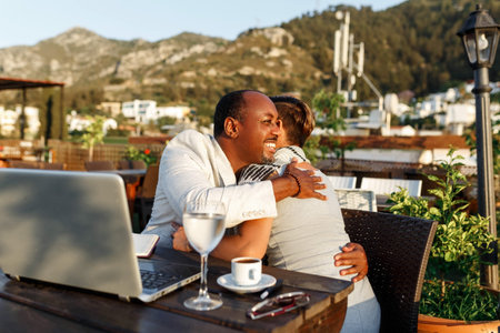 Coworking and freelance concept.Mixed race, middle age black skin man and woman working together on...