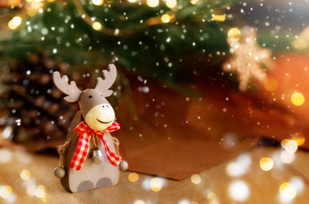 Christmas composition with holiday elk decoration.Burning lantern and christmas decoration on brown background, copy spaceの写真素材