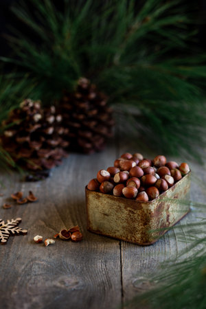 Christmas cookies in plate, festive tree and pine cones, bokeh light. Christmas sweets. Sugar powder...