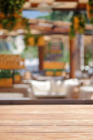 Empty wood table top and blurred summer beach in tropical resort banner background, display or montage, copy space, defocused.の写真素材