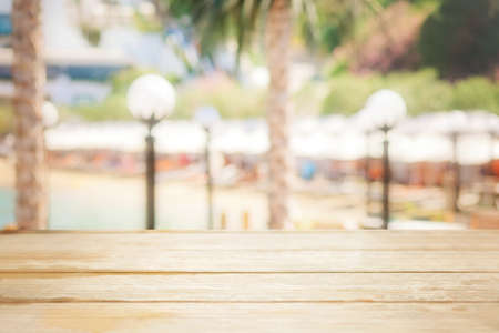Empty wood table top and blurred summer beach in tropical resort banner background, display or montage, copy space, defocused.の写真素材