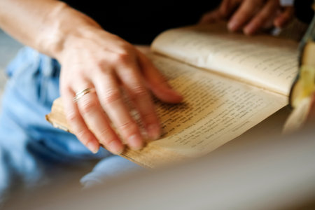Young beautiful cropped woman standing next to street bricks wall, denim jeans clothes, holding belt satchel purse in shoulder, summer fashion trend, close-up details.の写真素材
