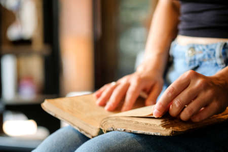 Close-up of womans hands with book, bookstore. Education, school, study, reading fiction conceptの写真素材