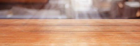 Wooden board empty table in front of blurred background. Perspective brown wood over blur in coffee shop .Mock up for display of product. Bannerの写真素材