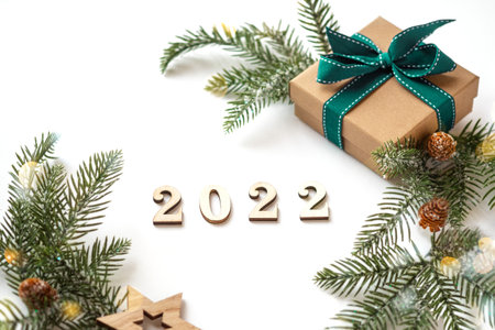 Xmas 2022 composition with present box decorations, wooden snowflakes, fir tree branches. Merry Christmas white background ,New Year concept for design template or mockup with copy spaceの写真素材