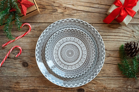 Creative Christmas table setting. Empty plates on rustic wooden xmas background