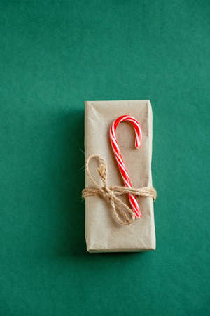 Craft paper envelopes tied with string and decorated with Christmas candy. Envelopes made of Kraft green paper and candyの写真素材