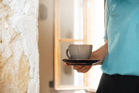 Woman holding elegant ceramic cup tea or coffee on stone background, closeupの写真素材