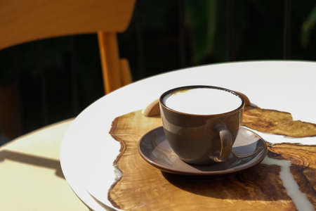 Cup of aromatic coffee cappuccino or latte on a wooden table. Concept of meeting or relaxing. Tasty morning drinksの写真素材
