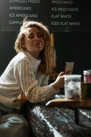Portrait of young caucasian woman using mobile phone, communication, chatting. Happy female holding...