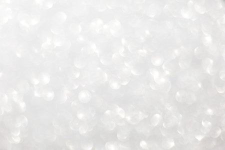 Defocused christmas or party, grey glitter background with bokeh. Holiday glowing backdrop,banner or...