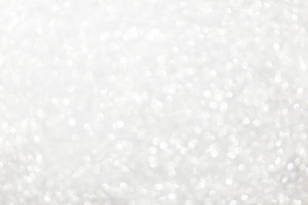 Defocused christmas or party, grey glitter background with bokeh. Holiday glowing backdrop,banner or cardの写真素材