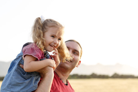 Happy father and child daughter spending time outdoors. Fathers Dayの写真素材