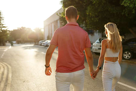 Couple has fun and laughs. Young hipster couple hugging each other in city. Summer love story, beautiful stylish young couple. Spring fashion urban concept with boyfriend and girlfriend.の写真素材