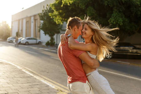 Couple has fun and laughs. Young hipster couple hugging each other in city. Summer love story, beautiful stylish young couple. Spring fashion urban concept with boyfriend and girlfriend.の写真素材