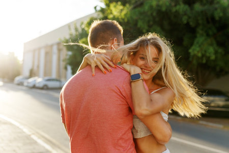 Couple has fun and laughs. Young hipster couple hugging each other in city. Summer love story,...
