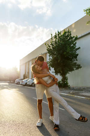 Couple has fun and laughs. Young hipster couple hugging each other in city. Summer love story, beautiful stylish young couple. Spring fashion urban concept with boyfriend and girlfriend.の写真素材