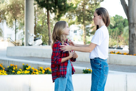 A woman hugs a teenage daughter and tries to understand her, to hear about her teenage problems. Mom is the best psychologist for her children. Mom and teen daughter communicateの写真素材