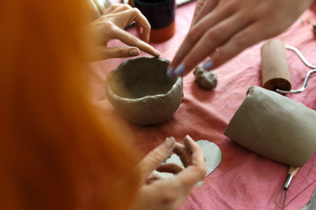 Pottery workshop class. A pottery crafts dish from a raw clay. Creating ceramics for adults