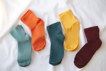 Isolated colorful socks with stripes on white background.
