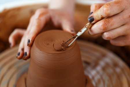 Female hands hold a bowl for casting clay products. Shaped method for making clay dishes. handwork. Pottery making.Close up.pottery wheelの写真素材