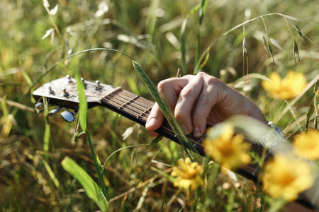 Mans hands playing acoustic guitar, close up. Acoustic guitars playing. Music concept. Guitars acoustic. Male musician playing guitar, music instrument.の写真素材
