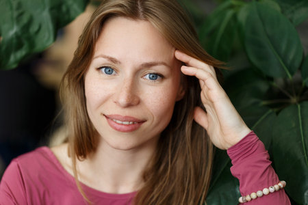 Happy young woman looking at the camera. Portrait of comfortable woman relaxing on armchair....