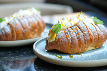 Sweet croissant sandwich dessert filled with whipped cream