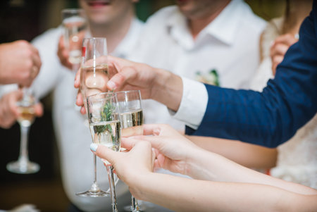 people at the wedding hold champagne glassesの写真素材