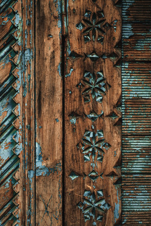 vintage wooden carved pattern with peeling blue paint, place for text