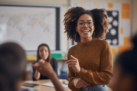 A cheerful African American female educator delivers an engaging lecture with a smileの素材
