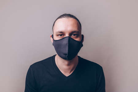 Young man in hand made fashion black medicine maskの写真素材