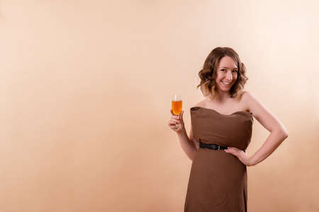 Young woman with orange drink on party isolatedの写真素材