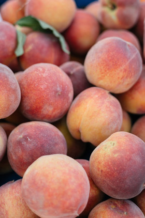 juicy fresh peaches on a stall at the marketの写真素材