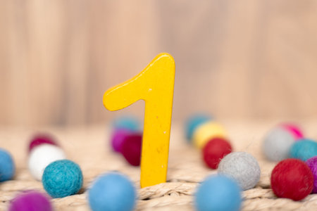 Close-up wooden figure number one on a beige blurred background, holiday date, anniversary, jubilee...