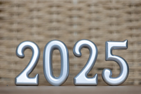Holiday neutral card with number 2025, Christmas and New Year celebrations, silver figures on beige...