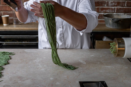 Process of woman preparing handmade pasta. Womans hands working with dough to make pasta. Chef...