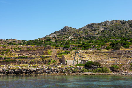 A scenic view of terraced hills in Turkiye, featuring lush greenery and rocky terrain under a clear blue sky. The landscape showcases natural beauty and agricultural land.の写真素材
