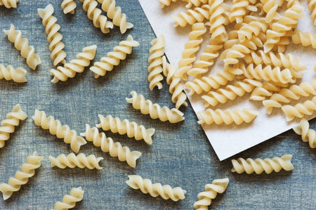 Raw pasta on the wooden table